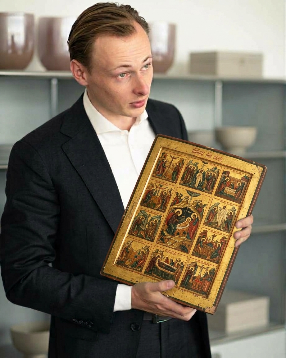 The curator of Tbilisi Icon Salon holding an Orthodox icon
